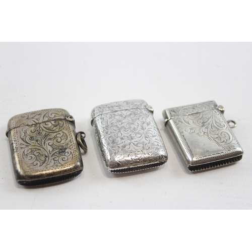 58 - Three silver vesta cases, Birmingham 1894,1928 and Chester 1900, 49gm