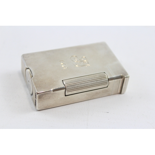 64 - A silver petrol lighter, Birmingham 1949, with ribbed decoration, engraved FS 1953, 5 x 3 x 1cm, 61g... 