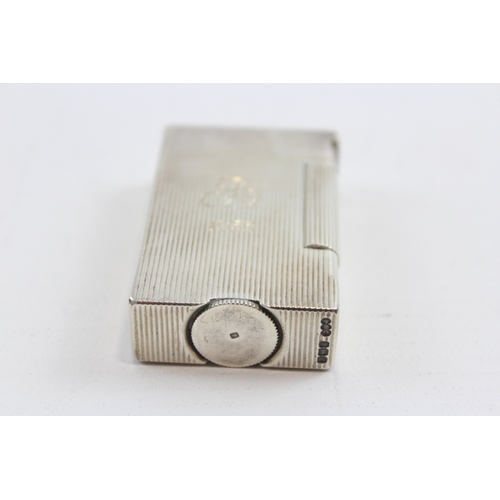 64 - A silver petrol lighter, Birmingham 1949, with ribbed decoration, engraved FS 1953, 5 x 3 x 1cm, 61g... 