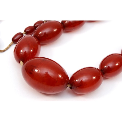 142 - A cherry red amber Bakelite graduated bead necklace, 32 - 8mm beads, 92cm, 76gm