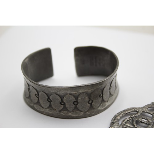 156 - Ide Knust, a Danish pewter bangle, a Norwegian pewter pendant and another pewter pendant