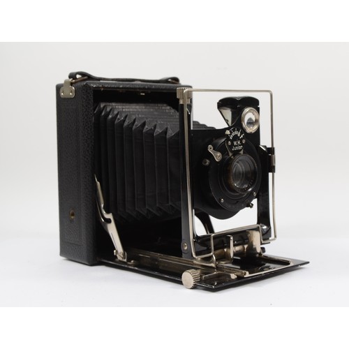 A W.H. Junior quarter plate folding camera, with a 135mm f6.8 lens
