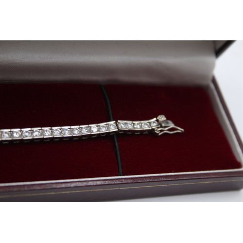 166 - A silver and white stone line bracelet, 18.5cm, and another similar, 25gm, both cased