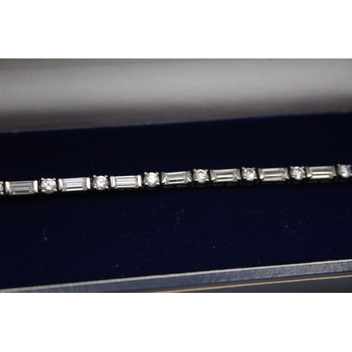 166 - A silver and white stone line bracelet, 18.5cm, and another similar, 25gm, both cased