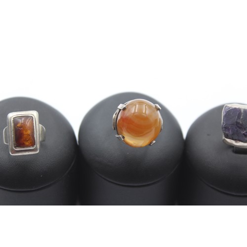 174 - N. E. From, a silver Norwegian and amber ring, M, sizing cracked and three other rings, 34gm