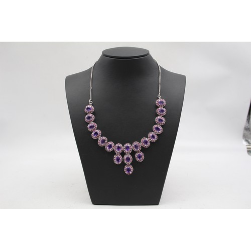 176 - A silver, amethyst and ruby suite of necklace, ear pendants and ring, 57gm