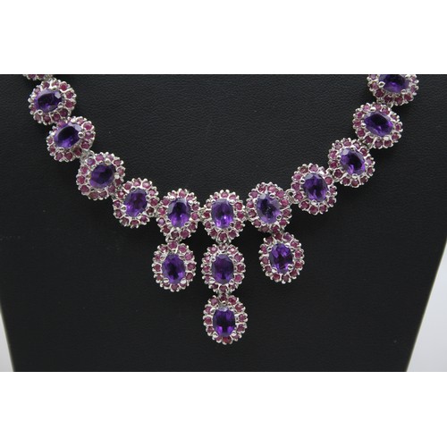 176 - A silver, amethyst and ruby suite of necklace, ear pendants and ring, 57gm