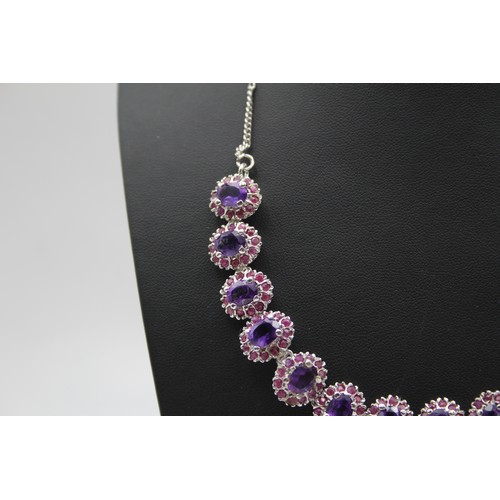 176 - A silver, amethyst and ruby suite of necklace, ear pendants and ring, 57gm