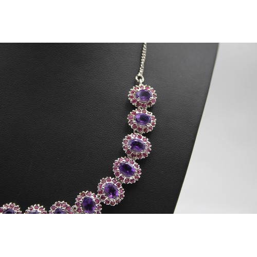 176 - A silver, amethyst and ruby suite of necklace, ear pendants and ring, 57gm