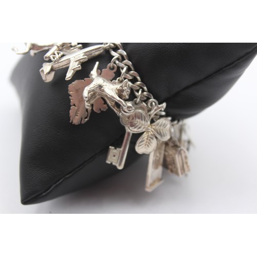 178 - A silver charm bracelet, 83gm