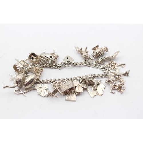 178 - A silver charm bracelet, 83gm