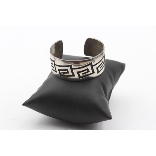 196 - A native American silver cuff bracelet, by Riley Polyquaptewa, with chased decoration, 25mm wide, 55... 