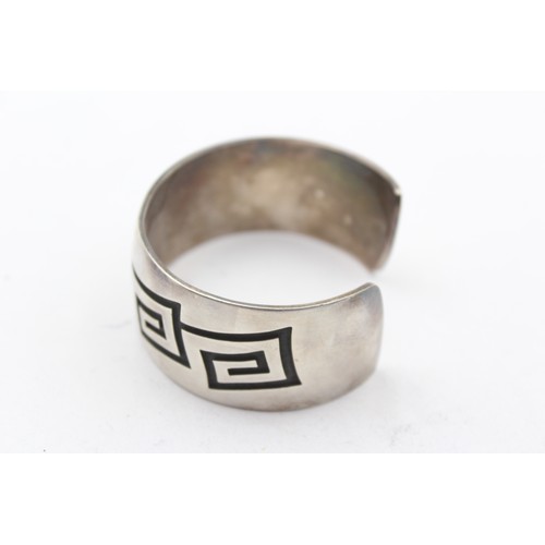 196 - A native American silver cuff bracelet, by Riley Polyquaptewa, with chased decoration, 25mm wide, 55... 