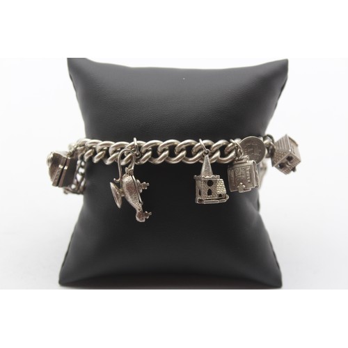 201 - A silver charm bracelet, 85gm