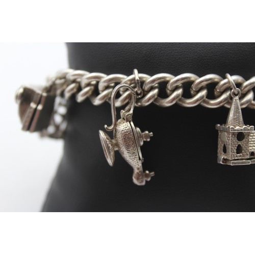 201 - A silver charm bracelet, 85gm