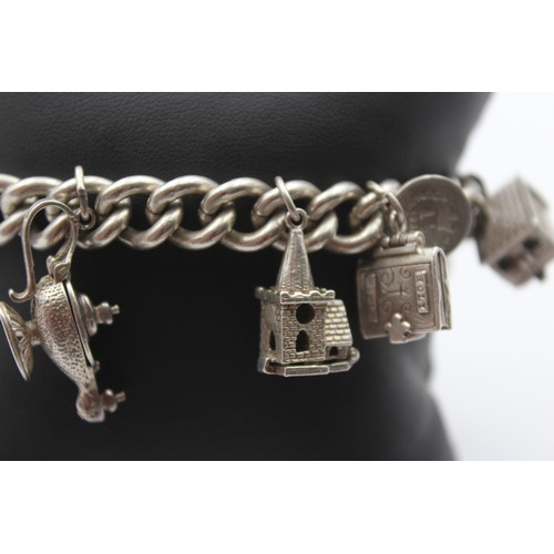 201 - A silver charm bracelet, 85gm