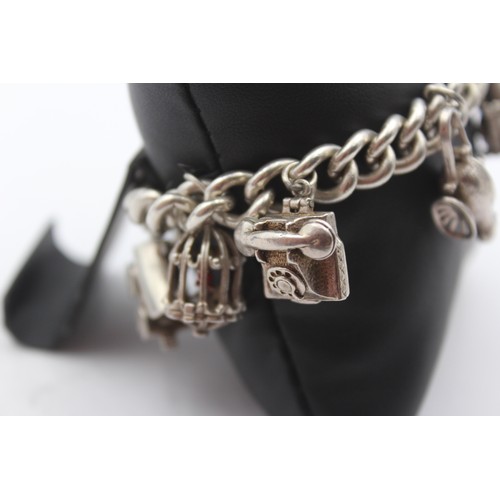 201 - A silver charm bracelet, 85gm