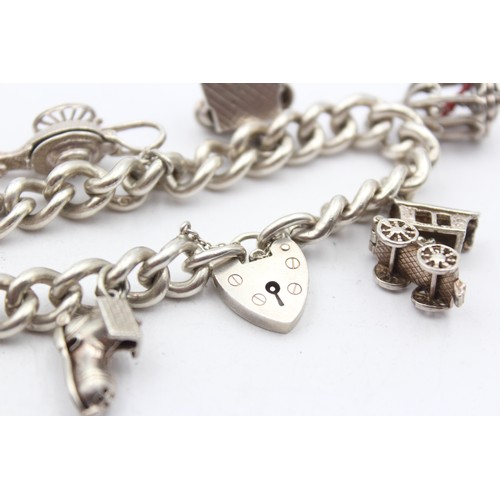 201 - A silver charm bracelet, 85gm