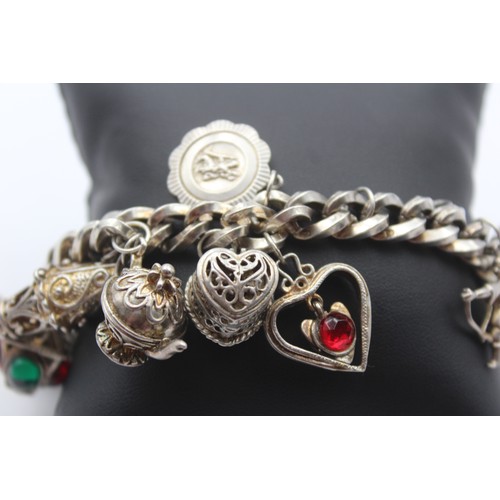 207 - A heavy silver charm bracelet, 111gm