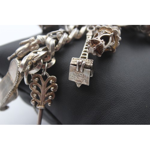 207 - A heavy silver charm bracelet, 111gm