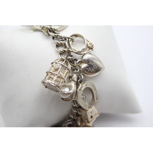 211 - A silver charm bracelet, 87gm