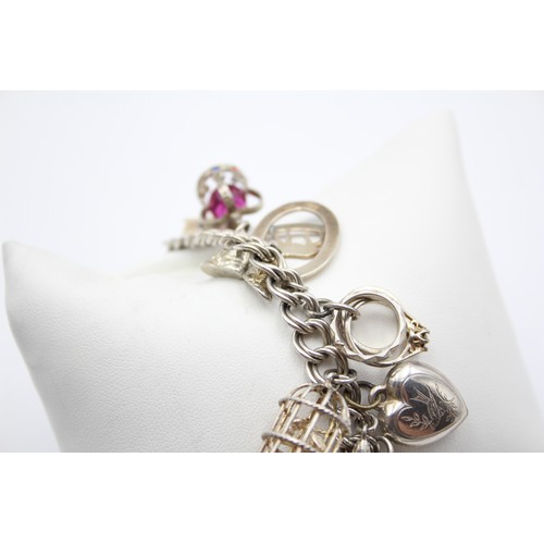 211 - A silver charm bracelet, 87gm