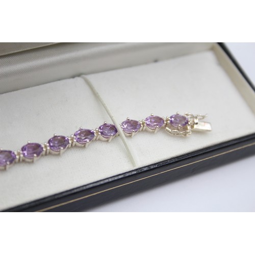 225 - A silver and amethyst line bracelet, 18cm and a silver gilt and peridot line bracelet, 19cm,