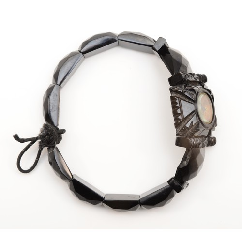 251 - A Victorian Whitby Jet facetted bracelet, the central panel inset with a compass.