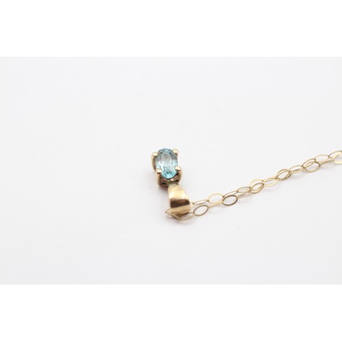 303 - A 9ct gold and blue topaz pendant, 10mm overall, chain, 0.7gm