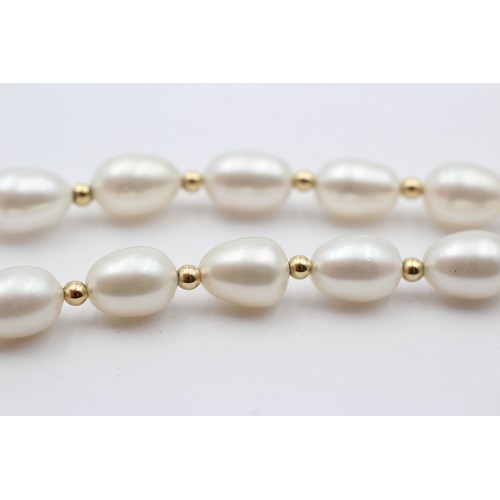 313 - A single row 10mm bead cultured pearl necklace with 14K gold beads between, 45cm