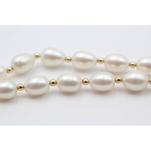 313 - A single row 10mm bead cultured pearl necklace with 14K gold beads between, 45cm