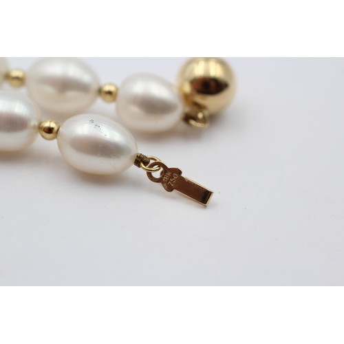 313 - A single row 10mm bead cultured pearl necklace with 14K gold beads between, 45cm