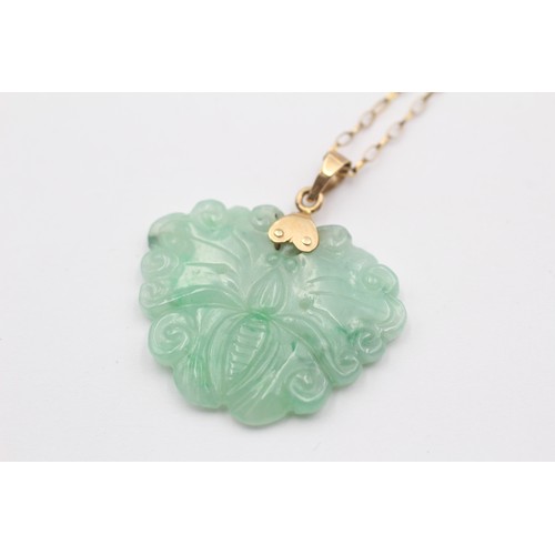 316 - A 14K gold mounted carved jadeite butterfly pendant, 28 x 22mm, 9ct gold chain.