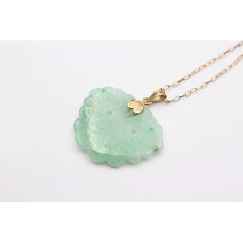 316 - A 14K gold mounted carved jadeite butterfly pendant, 28 x 22mm, 9ct gold chain.