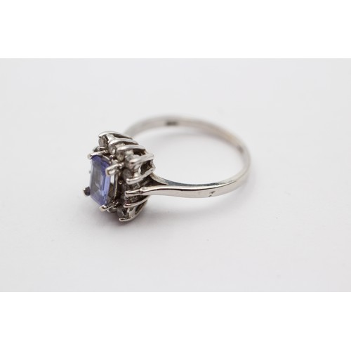 320 - A 9ct white gold tanzanite and diamond cluster ring, J 1/2, 2.6gm