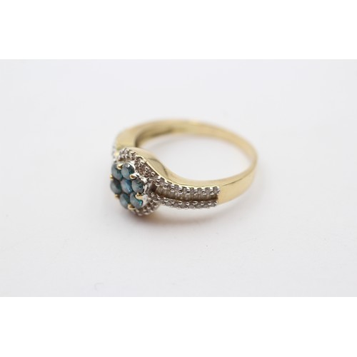 321 - A gold and diamond cluster ring, tests as 14K, enhanced brilliant cut blue diamonds with brilliant a... 