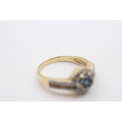 321 - A gold and diamond cluster ring, tests as 14K, enhanced brilliant cut blue diamonds with brilliant a... 