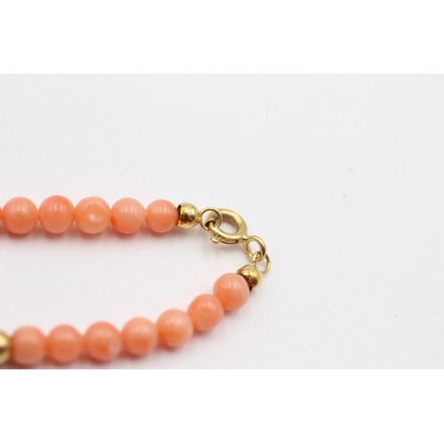 322 - A 4mm coral bead bracelet with 14K gold beads, 19cm