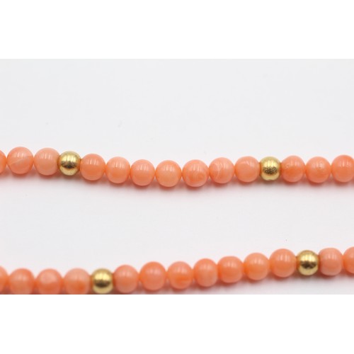 322 - A 4mm coral bead bracelet with 14K gold beads, 19cm