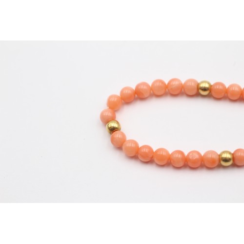 322 - A 4mm coral bead bracelet with 14K gold beads, 19cm