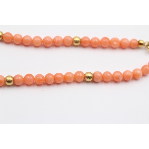 322 - A 4mm coral bead bracelet with 14K gold beads, 19cm