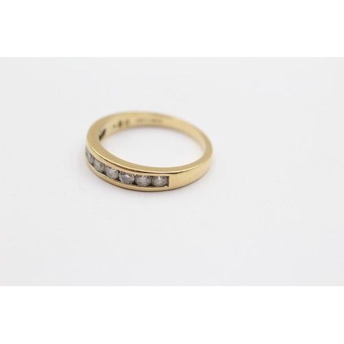 324 - An 18ct gold and brilliant cut diamond channel set half eternity ring, stated weight 0.50cts, L 1/2,... 