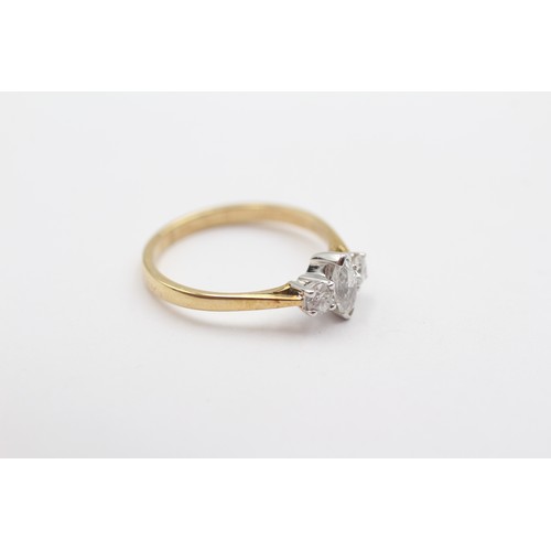 340 - An 18ct gold three stone diamond ring, claw set with a navette, flanked by brilliants, stated weight... 