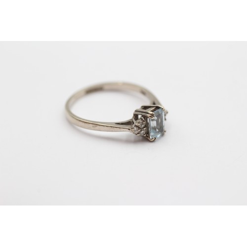 372 - A 9ct white gold step cut aquamarine ring, with brilliant cut diamond trefoil set shoulders, M, 2gm