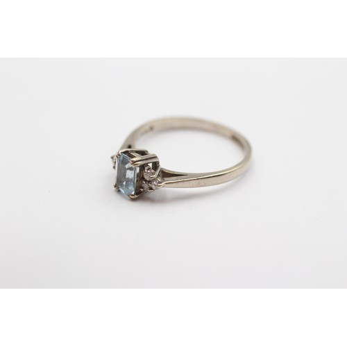 372 - A 9ct white gold step cut aquamarine ring, with brilliant cut diamond trefoil set shoulders, M, 2gm