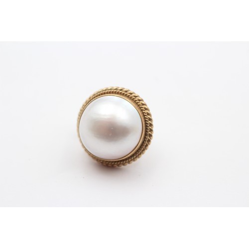 376 - A pair of 9ct gold and 13 mm Mabe pearl ear clips, 8.6gm