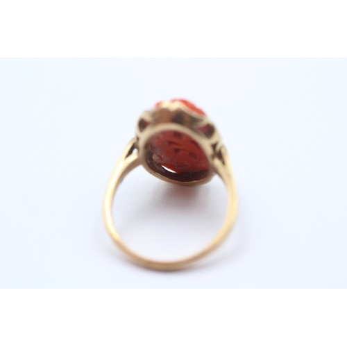 380 - A 10K gold carved coral panel ring, 20 x 12mm, P, 4.6gm