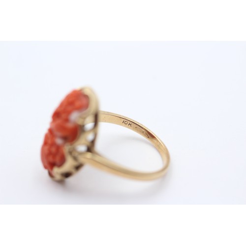 380 - A 10K gold carved coral panel ring, 20 x 12mm, P, 4.6gm