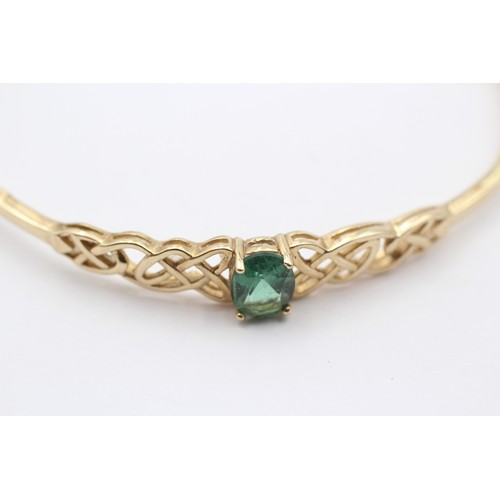 381 - A 9ct gold and green stone twist opening bangle, internal 60 x 52mm, 4.6gm