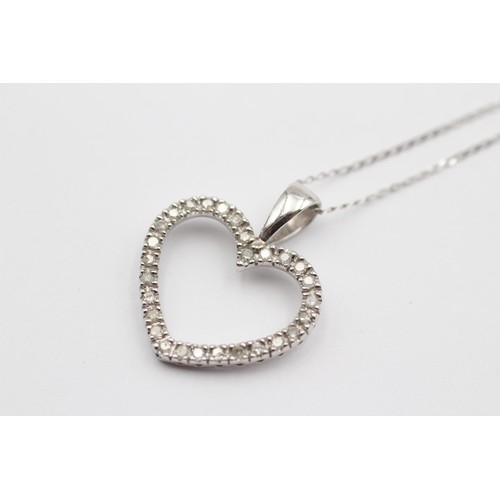 392 - A 9ct white gold and diamond openwork heart pendant, 20 x 17mm, chain, 1.7gm